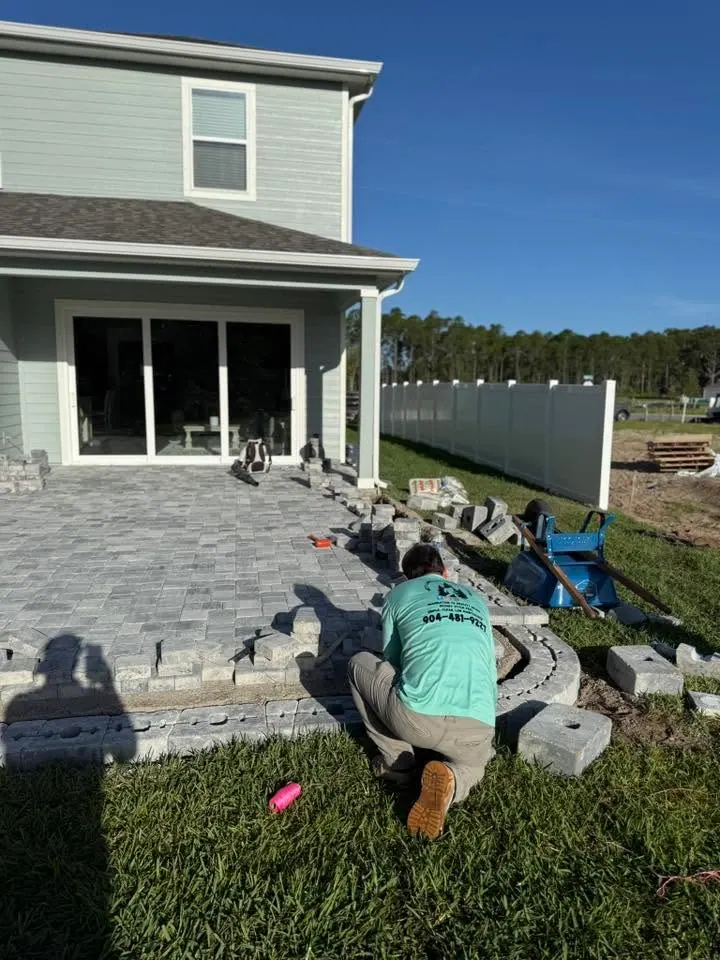 Yetti crew member laying pavers after an old landscape was removed